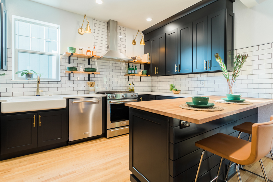 Kitchen with tile backslash and black cabinets