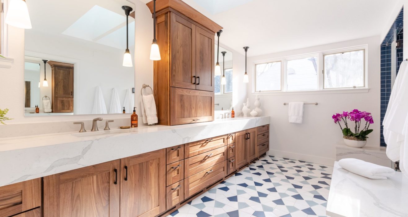 Bathroom remodel with rich wooden cabinets and white countertop