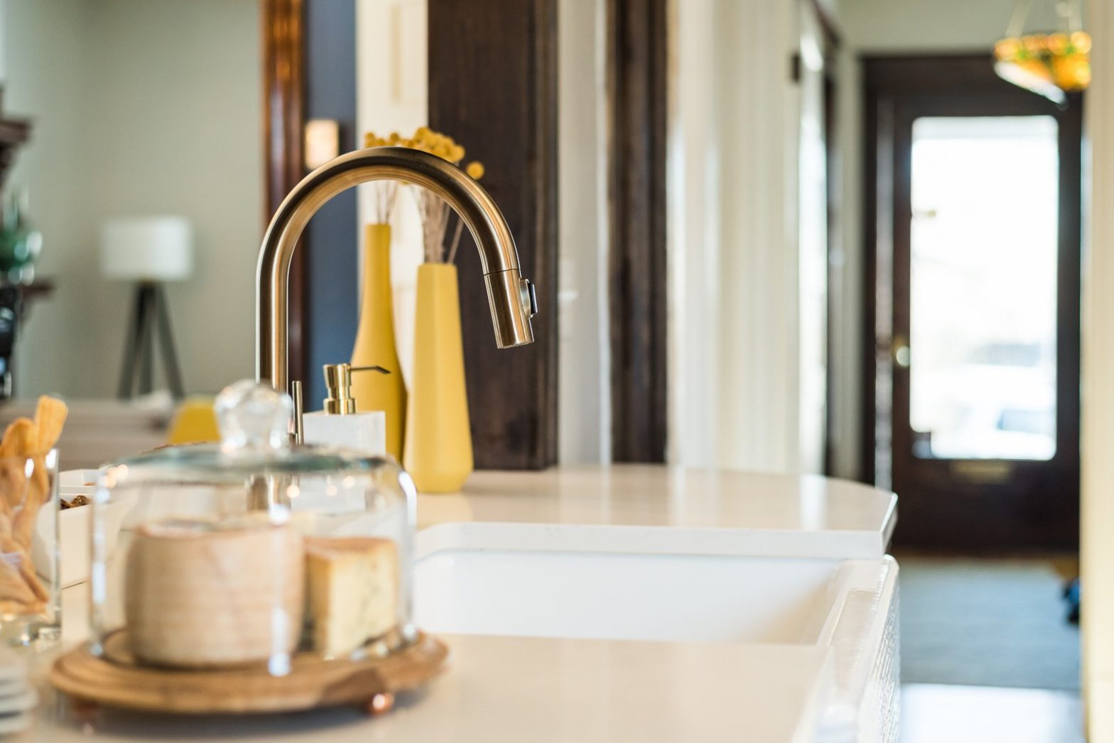 close up of kitchen sink with bakery items on counter