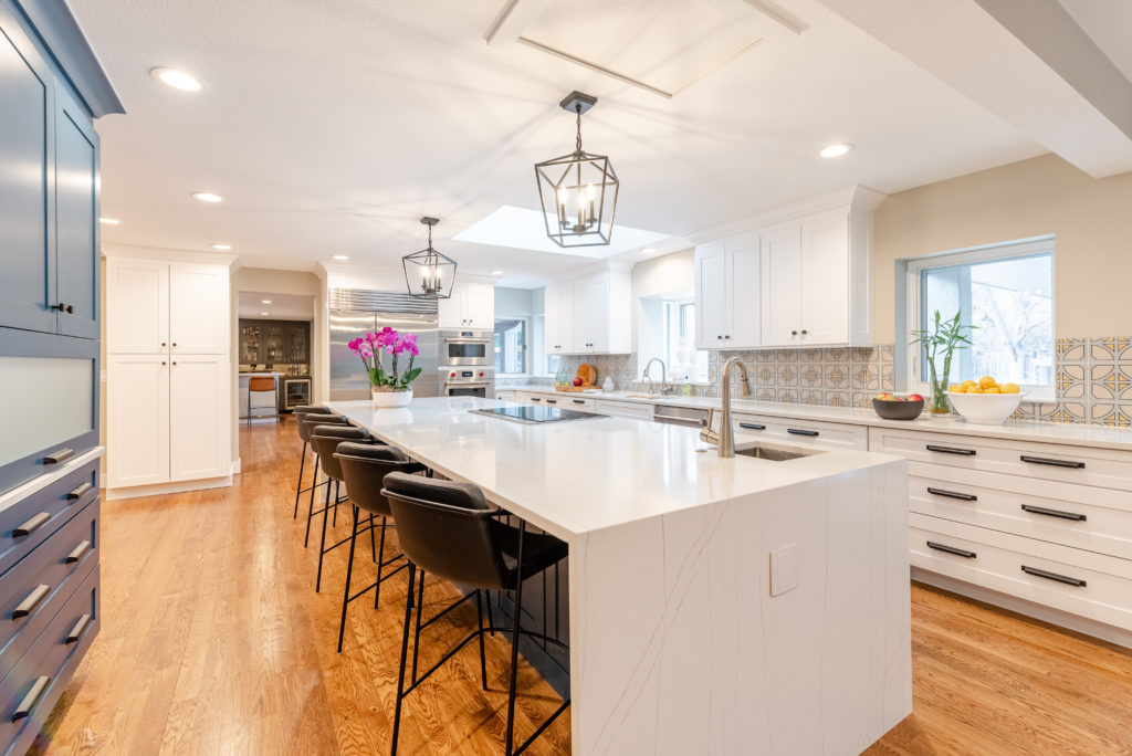 open-space kitchen with white counter tops and blue cabinets